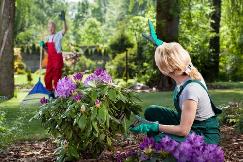 Team member preparing equipment for Millbank lawn care service